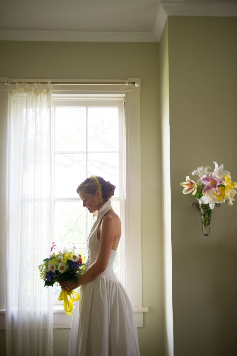 Bride looking out window